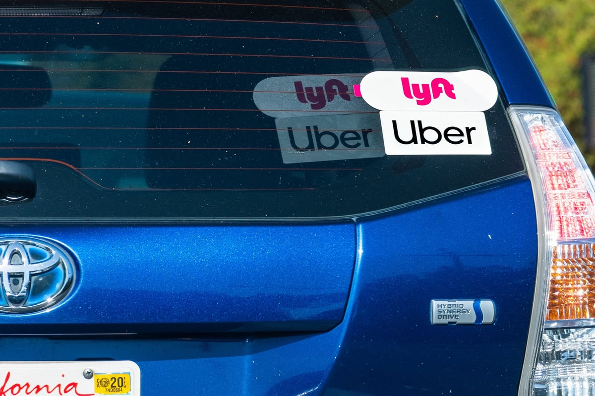 Hybrid vehicle used for rideshare and delivery work parked on a city street