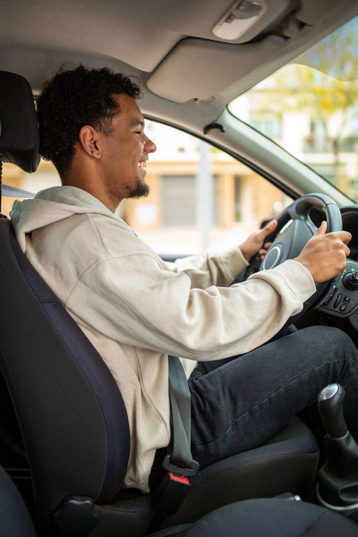 Driver holding the steering wheel of a Ford Fusion sedan