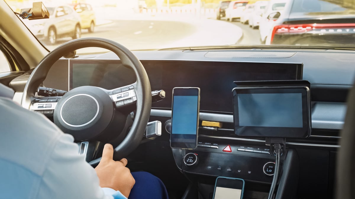 Driver behind the steering wheel following GPS navigation in a busy city